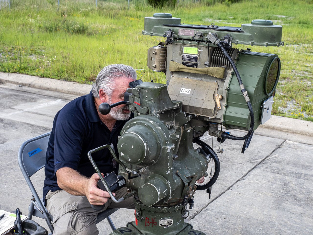 Man looking through military equipment